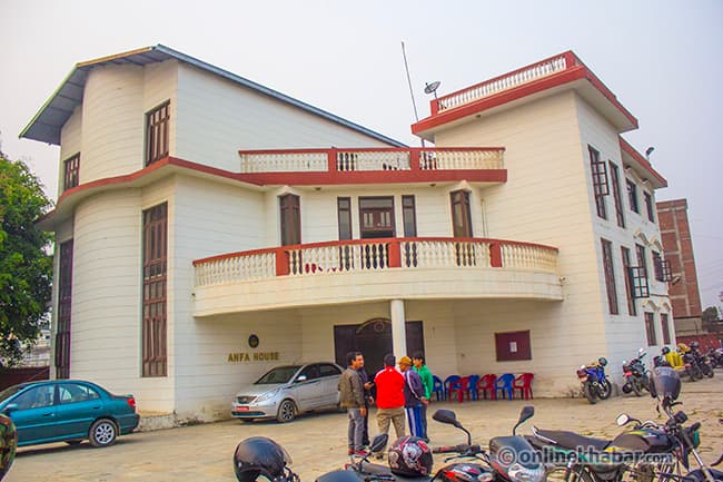 The ANFA House building in Satdobato with people standing in the parking area.
