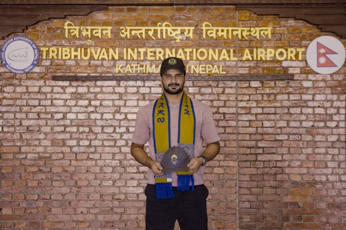 A cricketer standing at Tribhuvan International Airport.