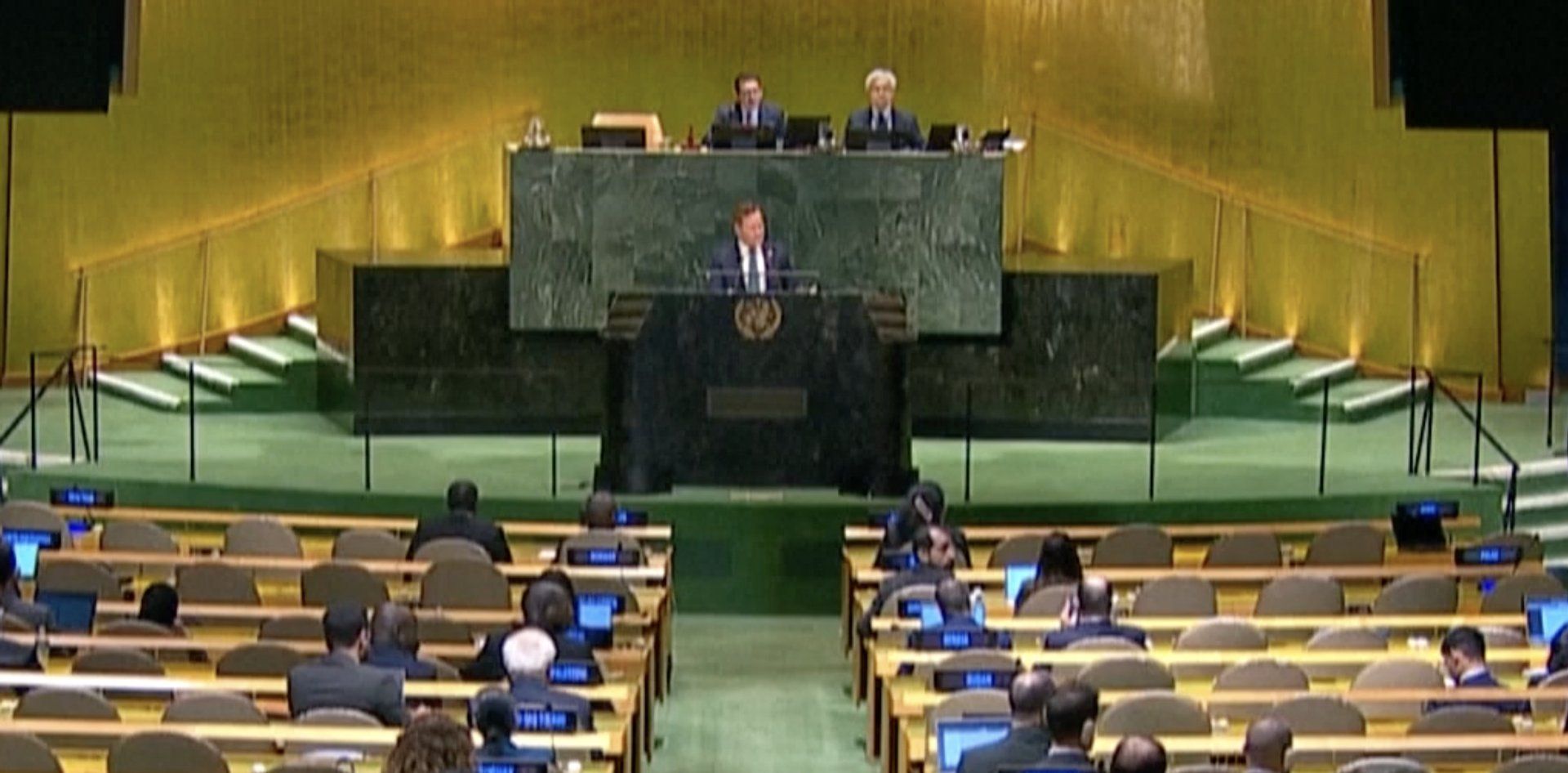 The United Nations General Assembly hall with a speaker at the podium.