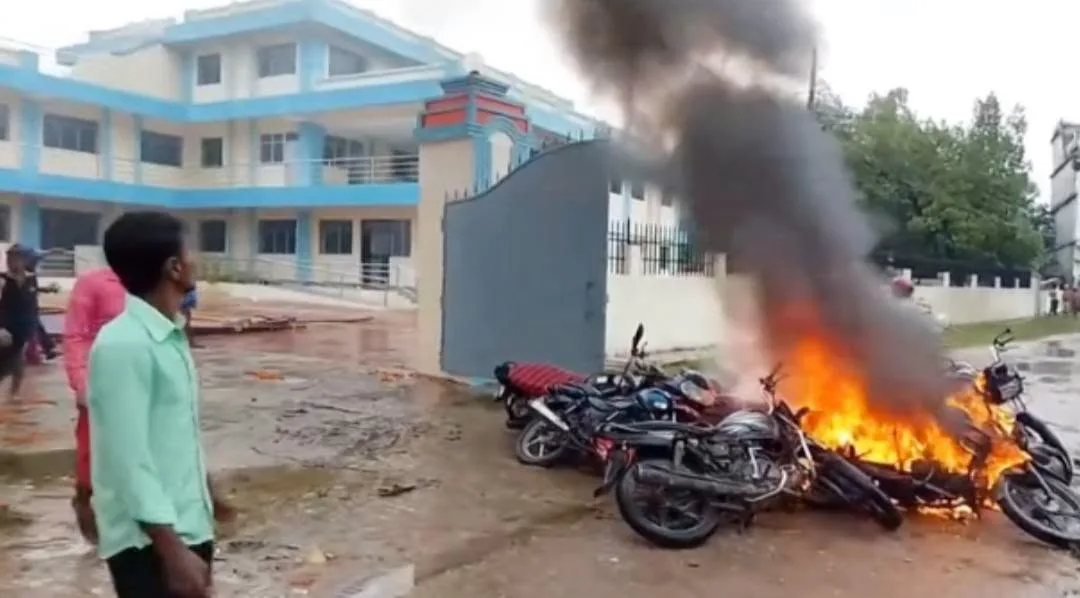 Motorcycles burning in front of a building during a protest in Bara.