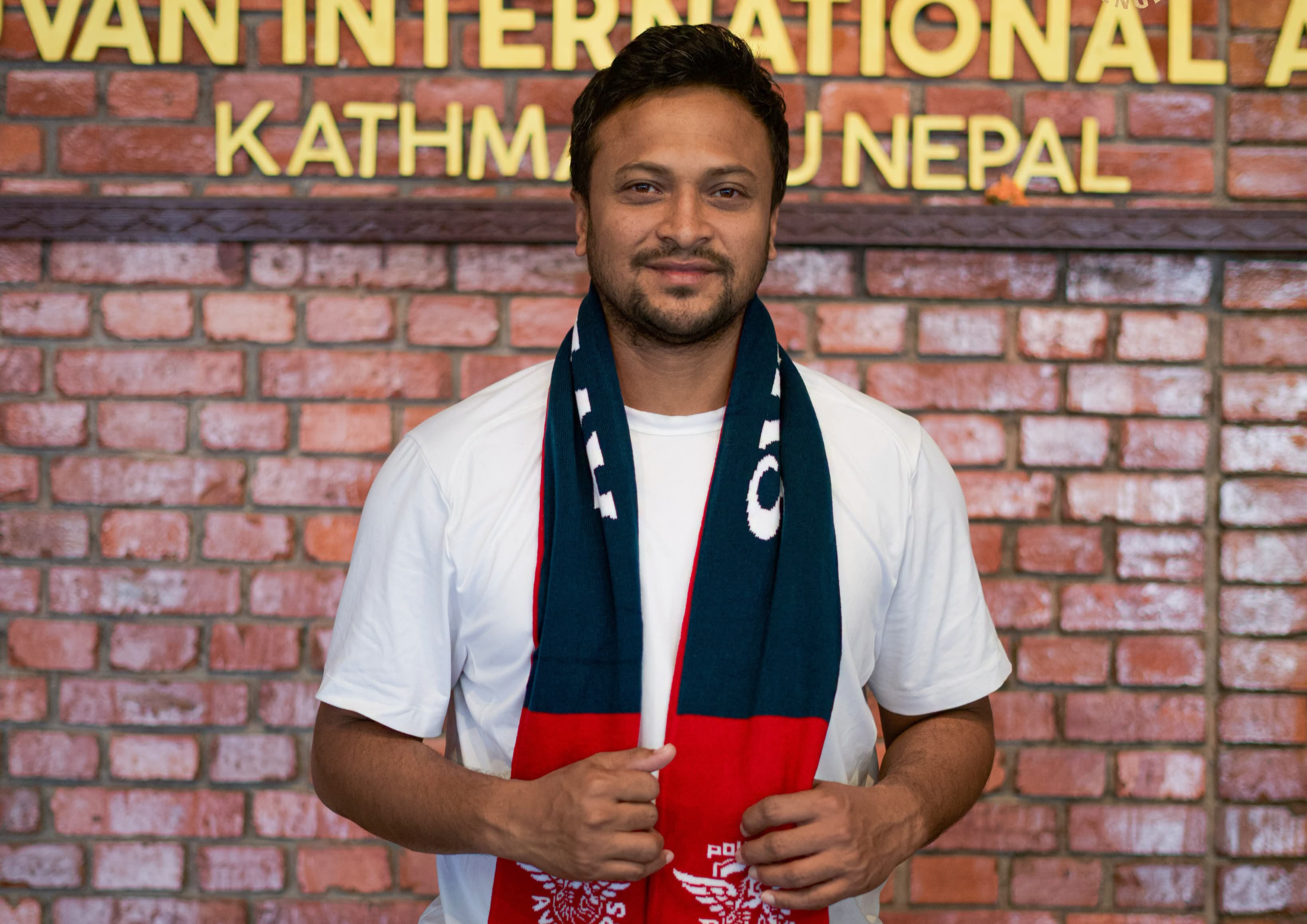 Shakib Al Hasan wearing a Pokhara Avengers scarf.