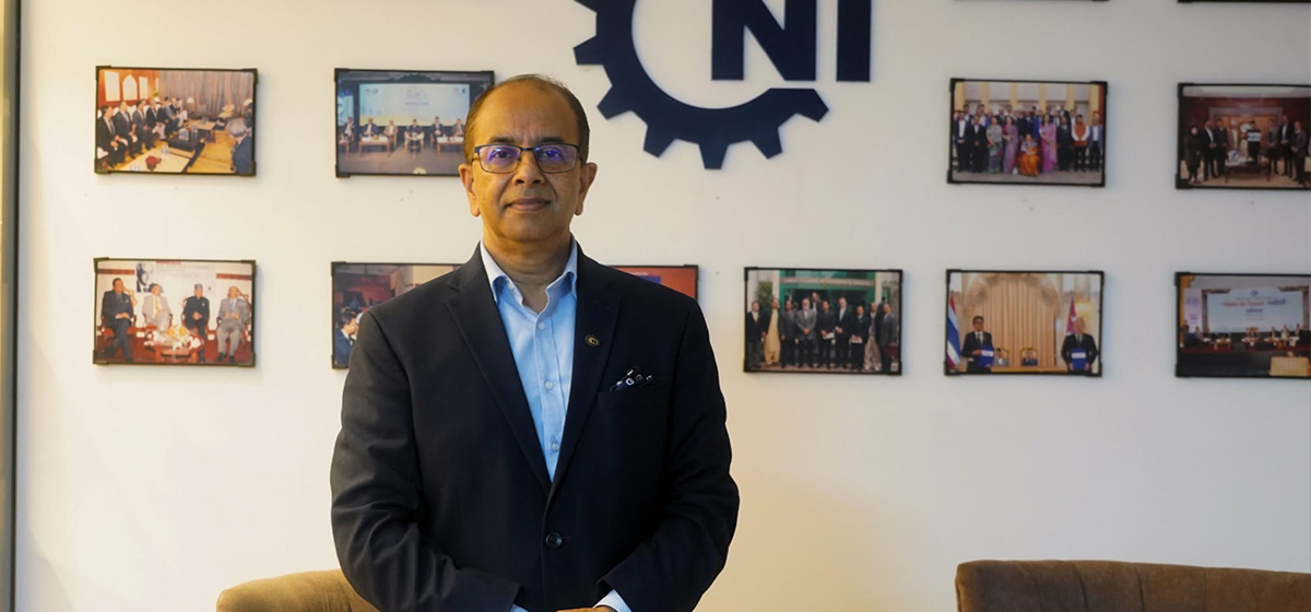 Confederation of Nepalese Industries President Birendra Raj Pandey standing in front of the CNI logo.