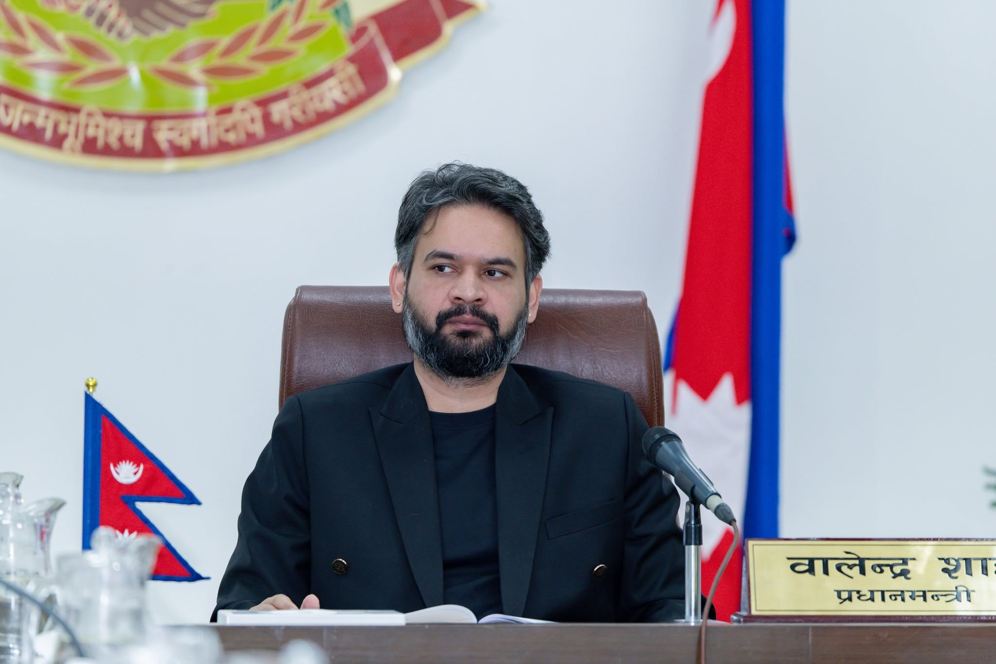 Prime Minister Balen Shah sitting at a desk with a microphone in front of him.