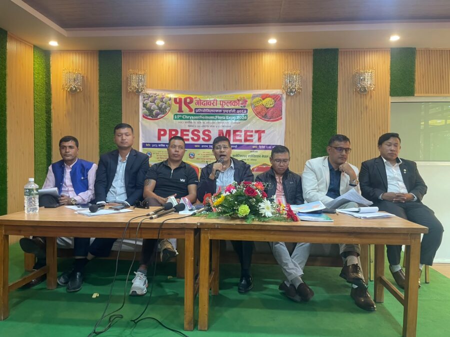 A group of men sitting at a table during a press conference for the 19th Chrysanthemum Flora Expo.