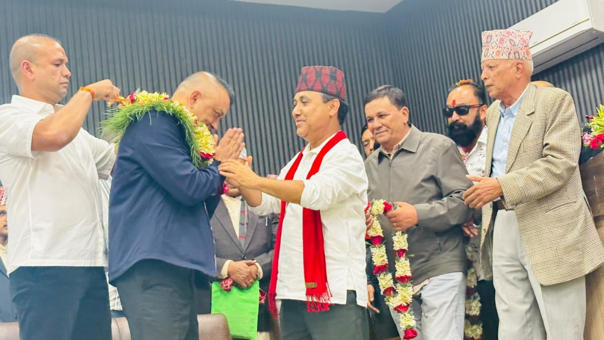 Nepali Congress members participating in a formal garland ceremony.