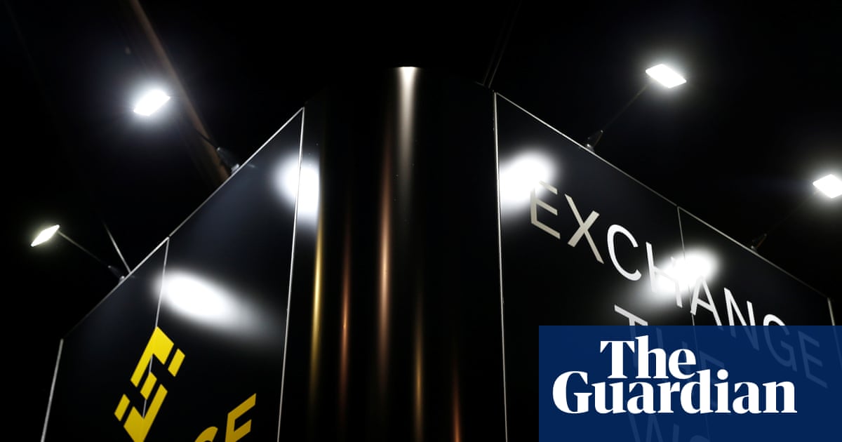A sign for Binance with the text 'Exchange the world'.