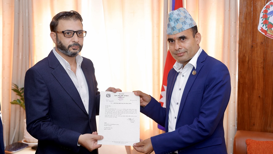 Two men in formal suits holding an official document.