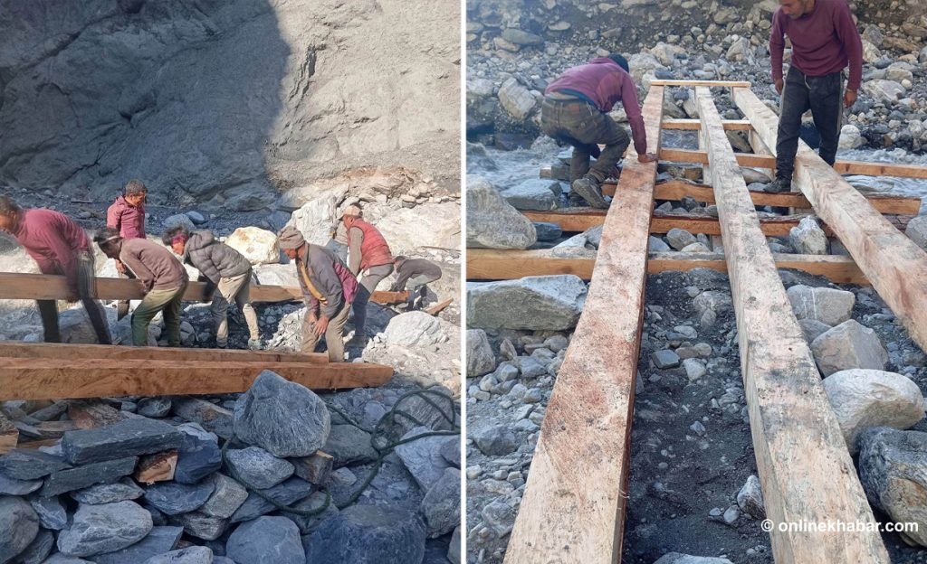 Local residents working together to build a wooden bridge.